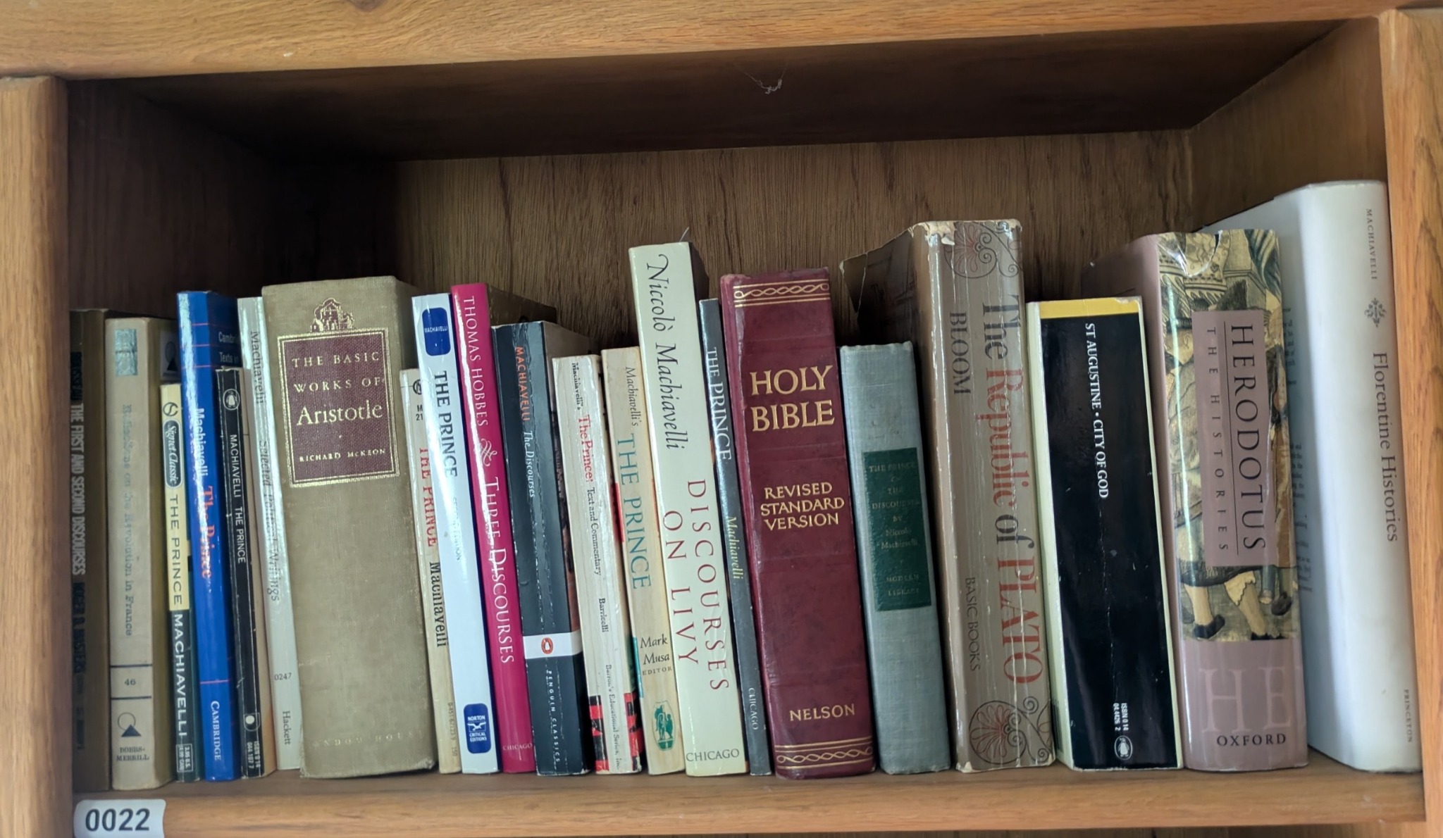 Photograph of Shelf 22 with readable book spines.
