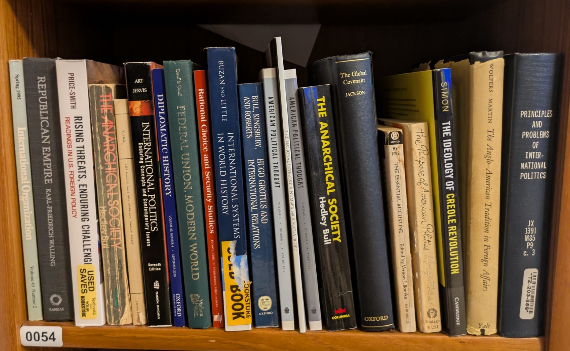 Photograph of Shelf 54 with readable book spines.