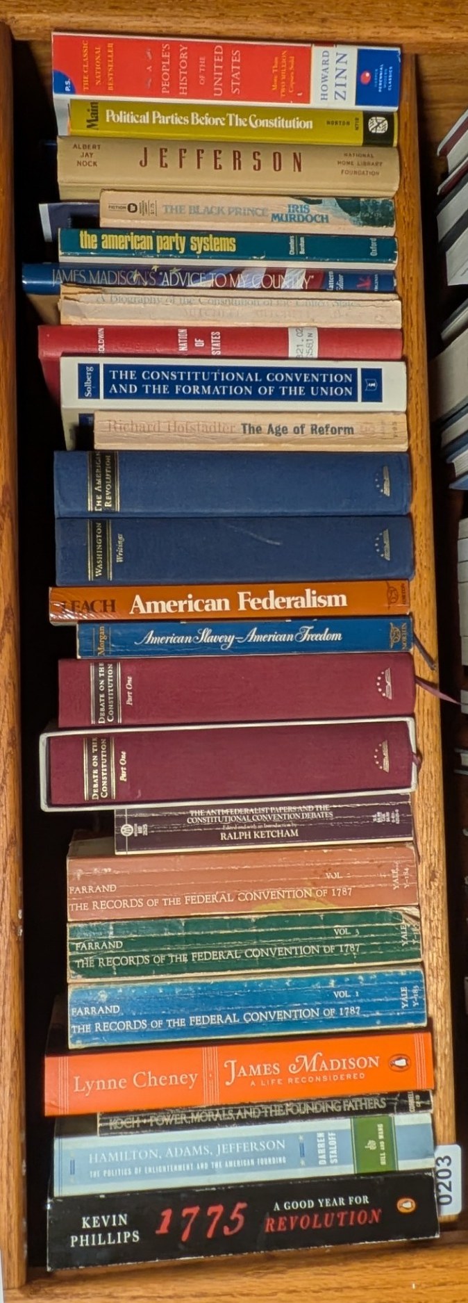 Photograph of Shelf 203 with readable book spines.