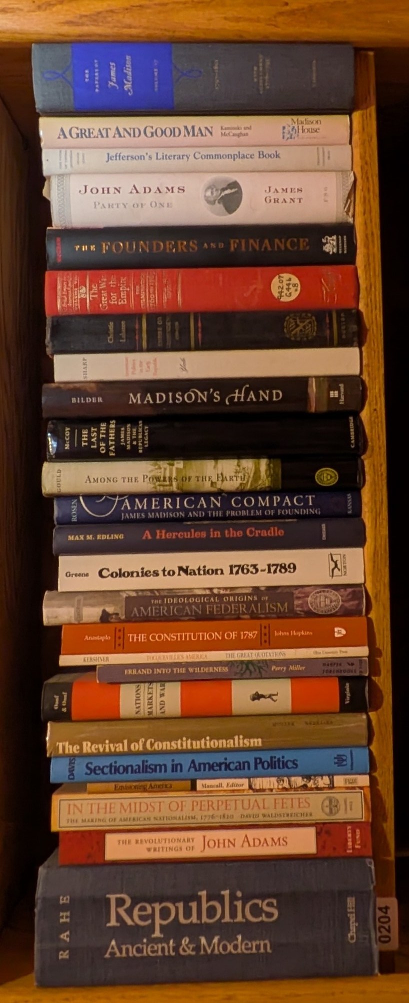 Photograph of Shelf 204 with readable book spines.