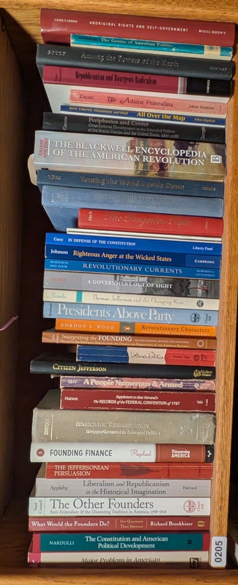 Photograph of Shelf 205 with readable book spines.