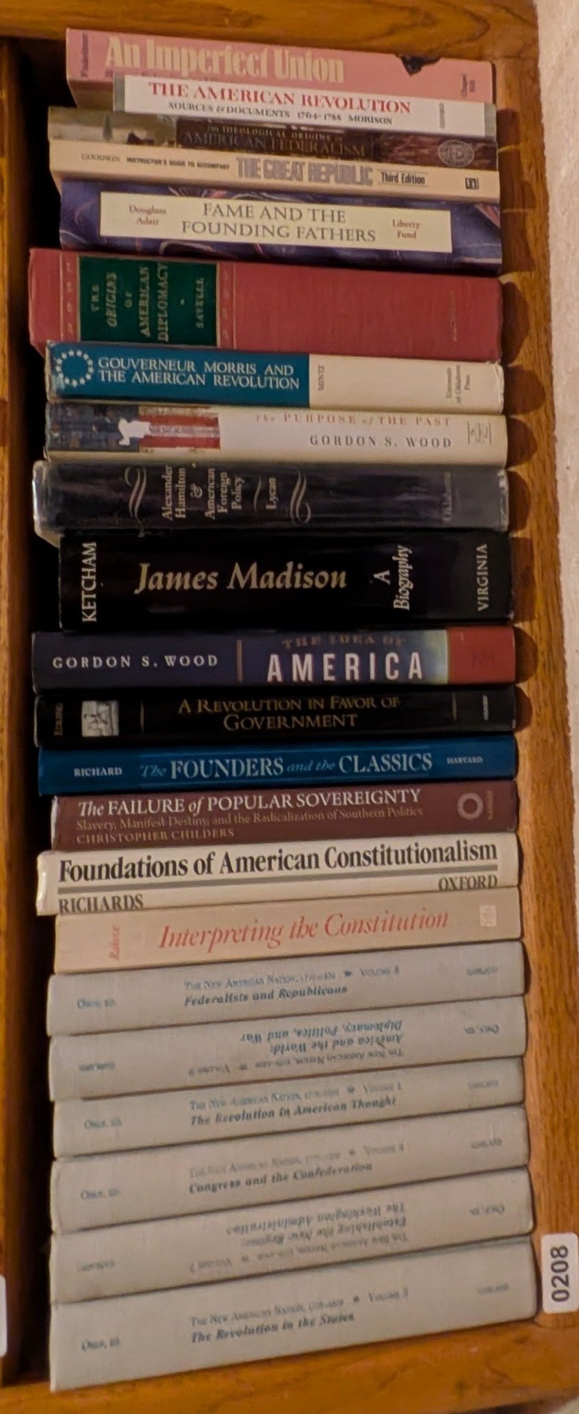 Photograph of Shelf 208 with readable book spines.