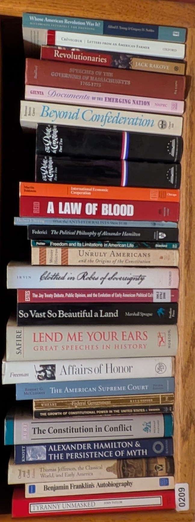 Photograph of Shelf 209 with readable book spines.
