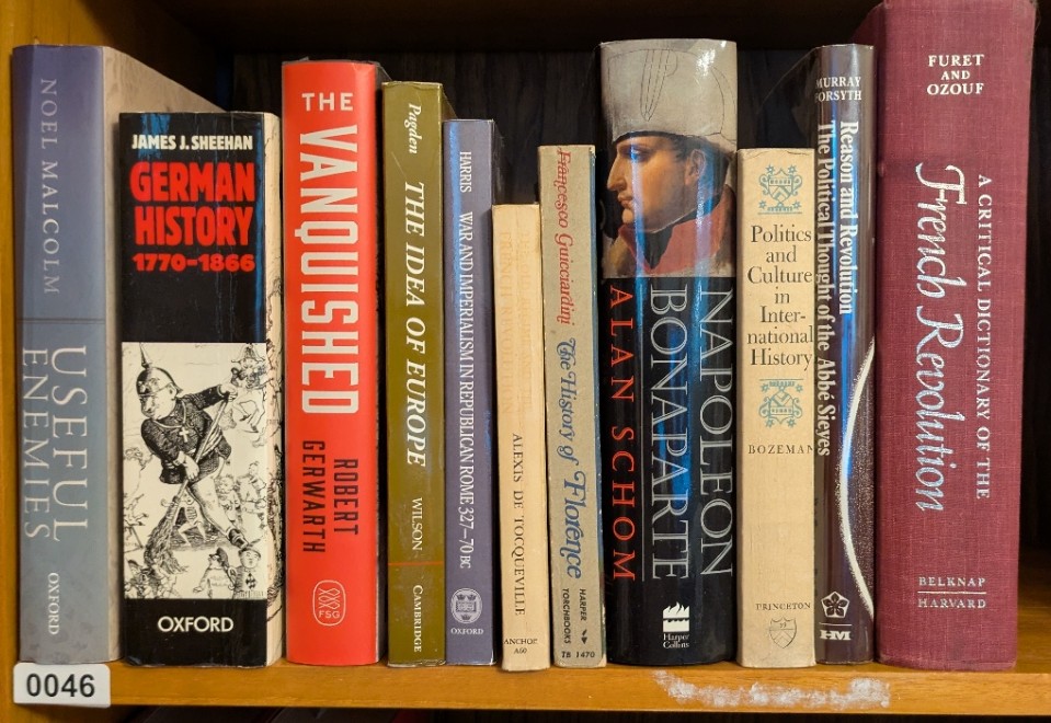 Photograph of Shelf 46; books are listed in top-to-bottom order alongside the photograph.