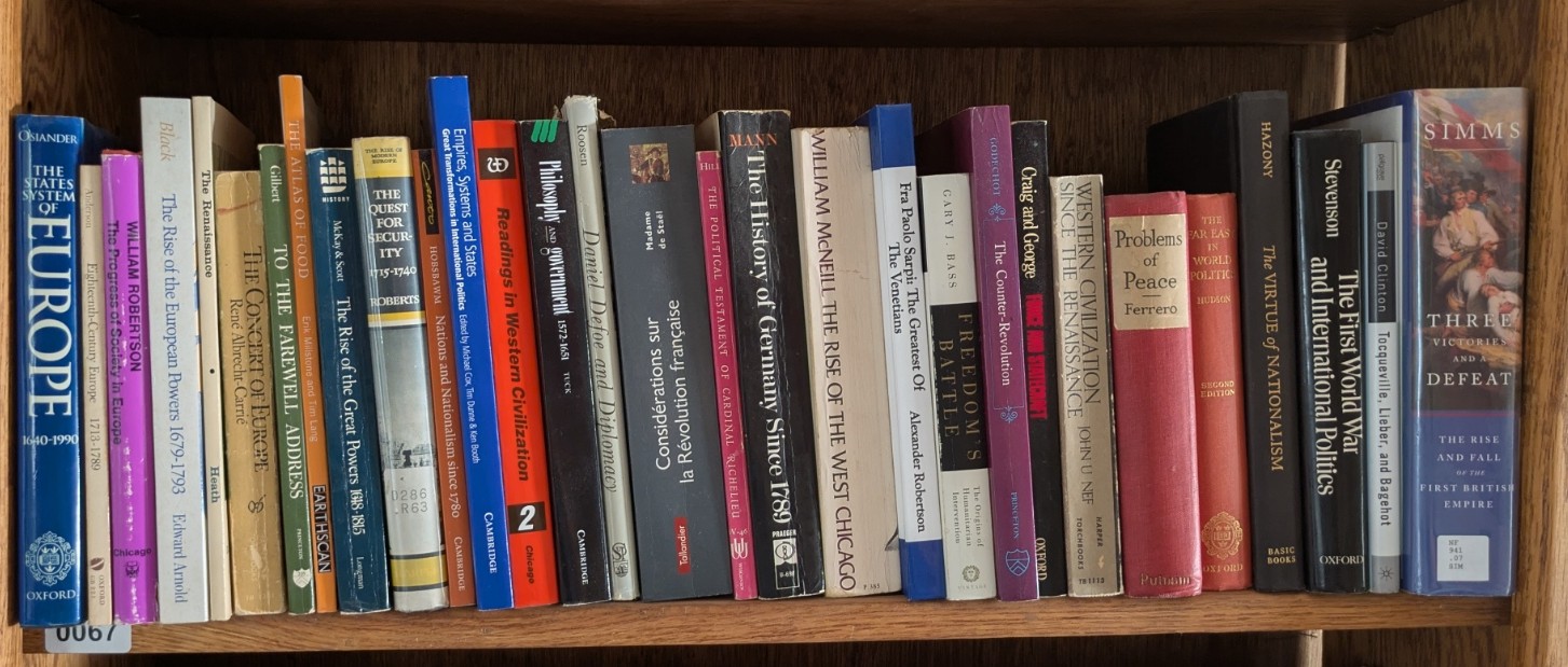 Photograph of Shelf 67; books are listed in top-to-bottom order alongside the photograph.