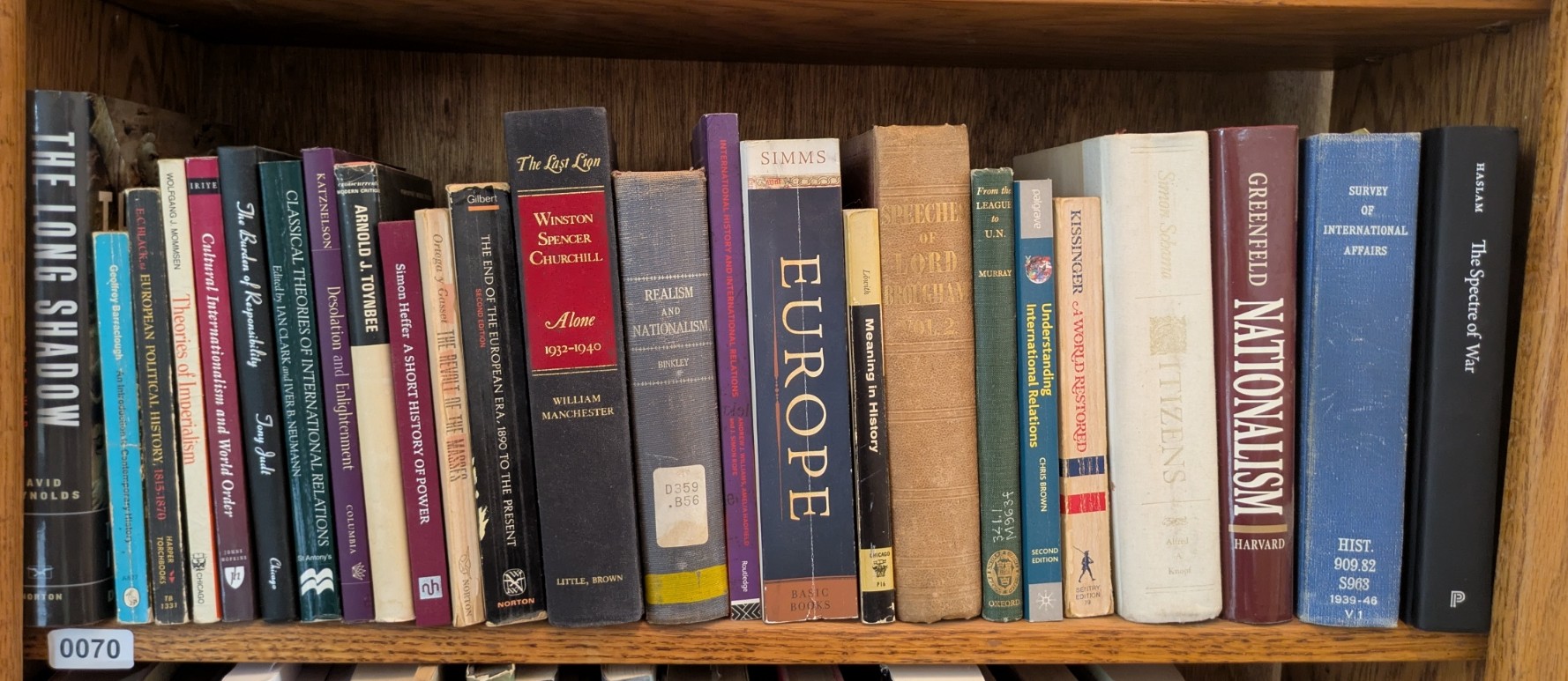 Photograph of Shelf 70; books are listed in top-to-bottom order alongside the photograph.