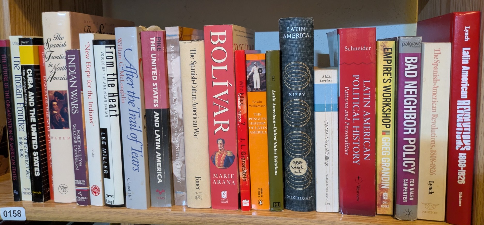 Photograph of Shelf 158; books are listed in top-to-bottom order alongside the photograph.