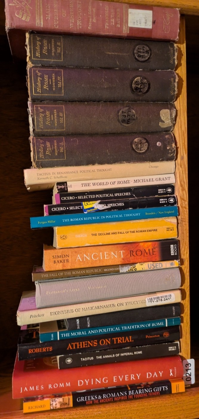 Photograph of Shelf 213; books are listed in top-to-bottom order alongside the photograph.