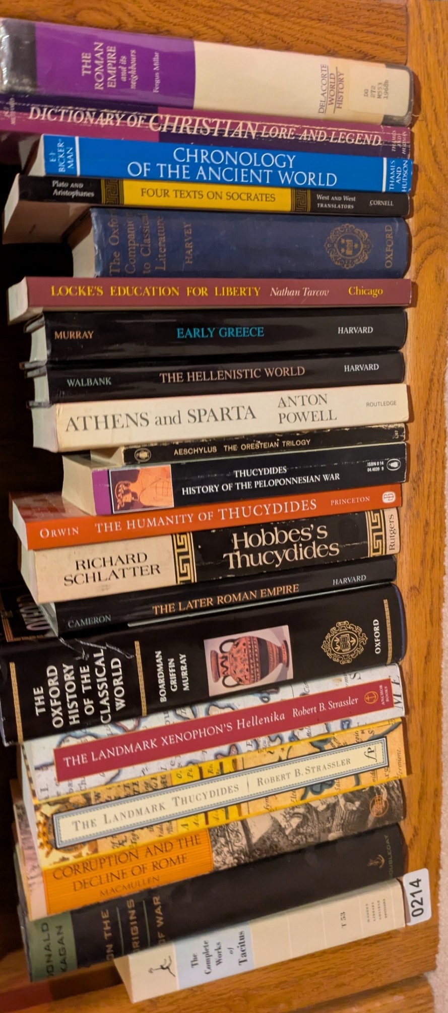 Photograph of Shelf 214; books are listed in top-to-bottom order alongside the photograph.