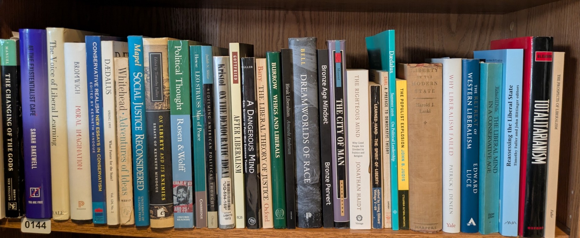 Photograph of Shelf 144 with readable book spines.