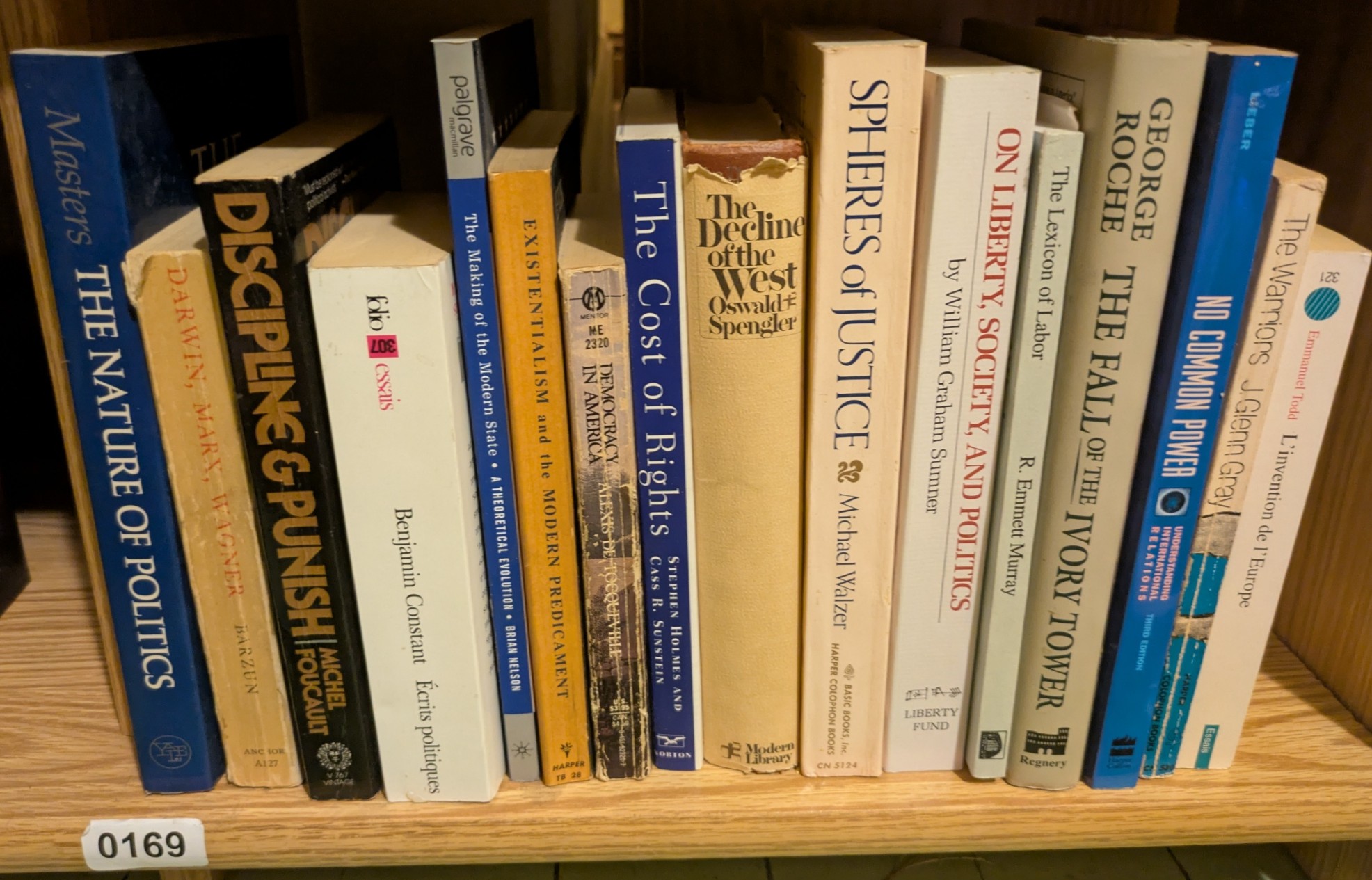Photograph of Shelf 169 with readable book spines.
