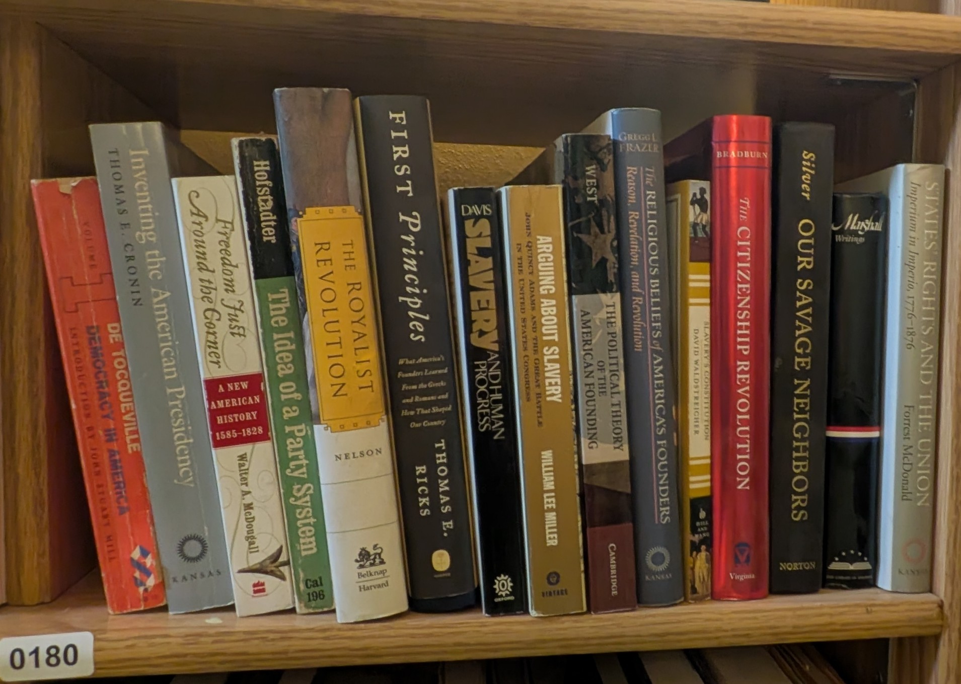 Photograph of Shelf 180 with readable book spines.