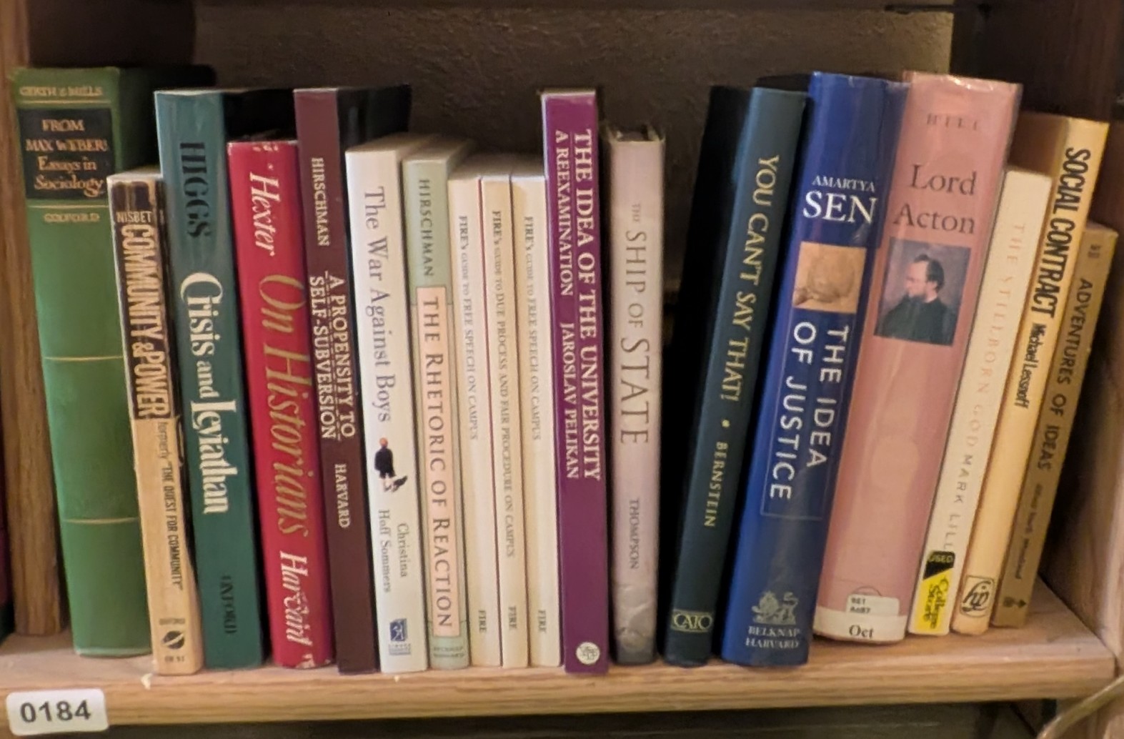 Photograph of Shelf 184 with readable book spines.