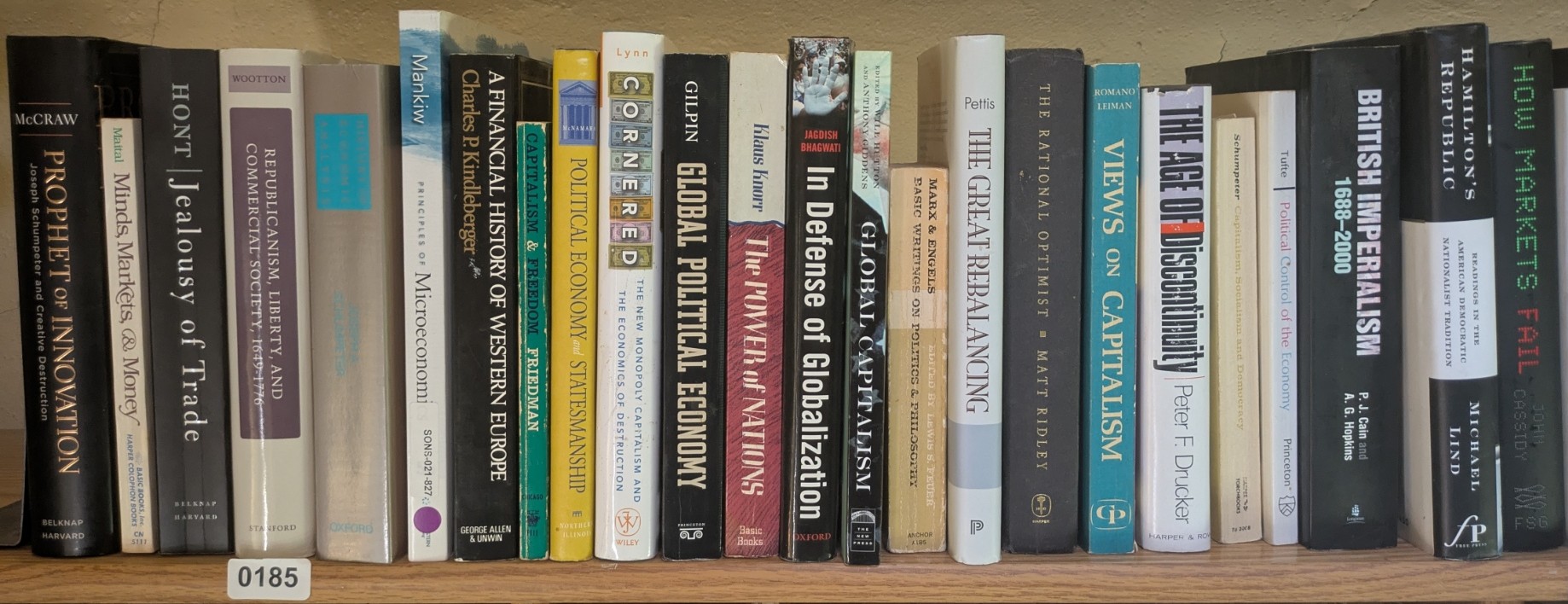 Photograph of Shelf 185; books are listed in top-to-bottom order alongside the photograph.