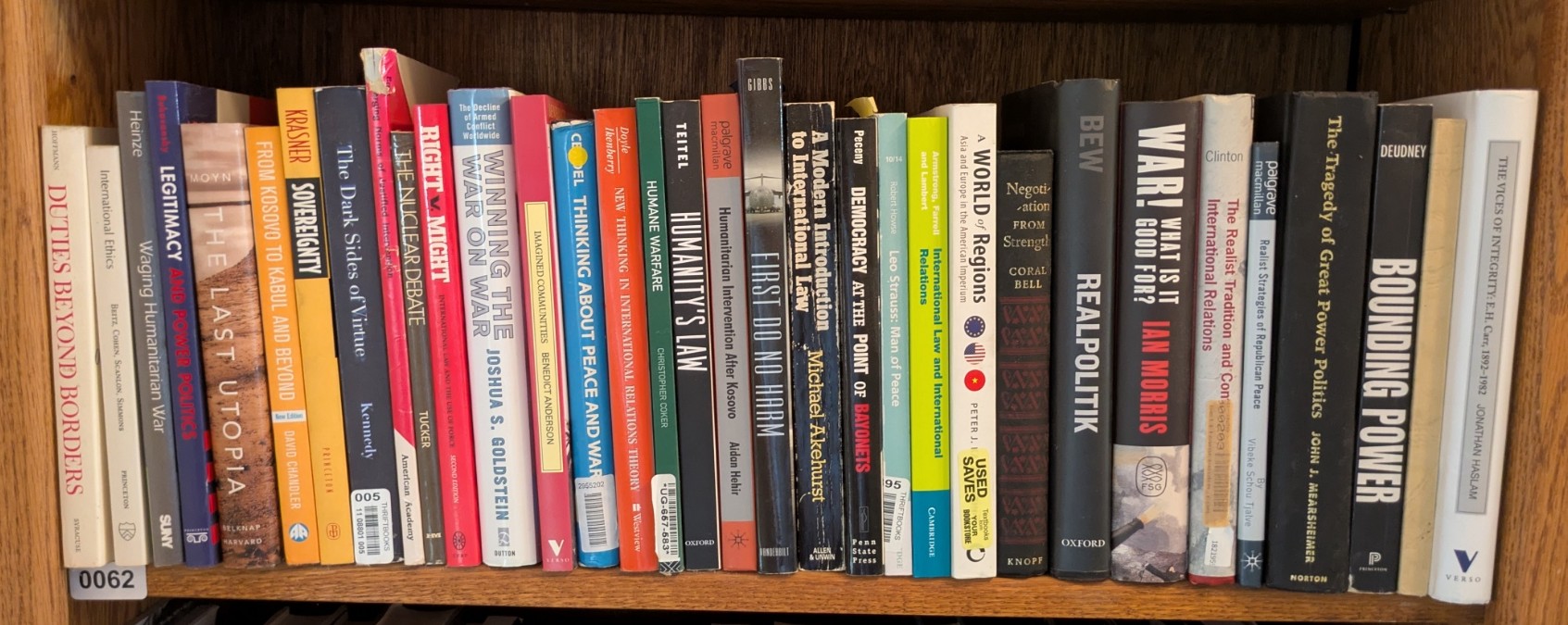 Photograph of Shelf 62; books are listed in top-to-bottom order alongside the photograph.