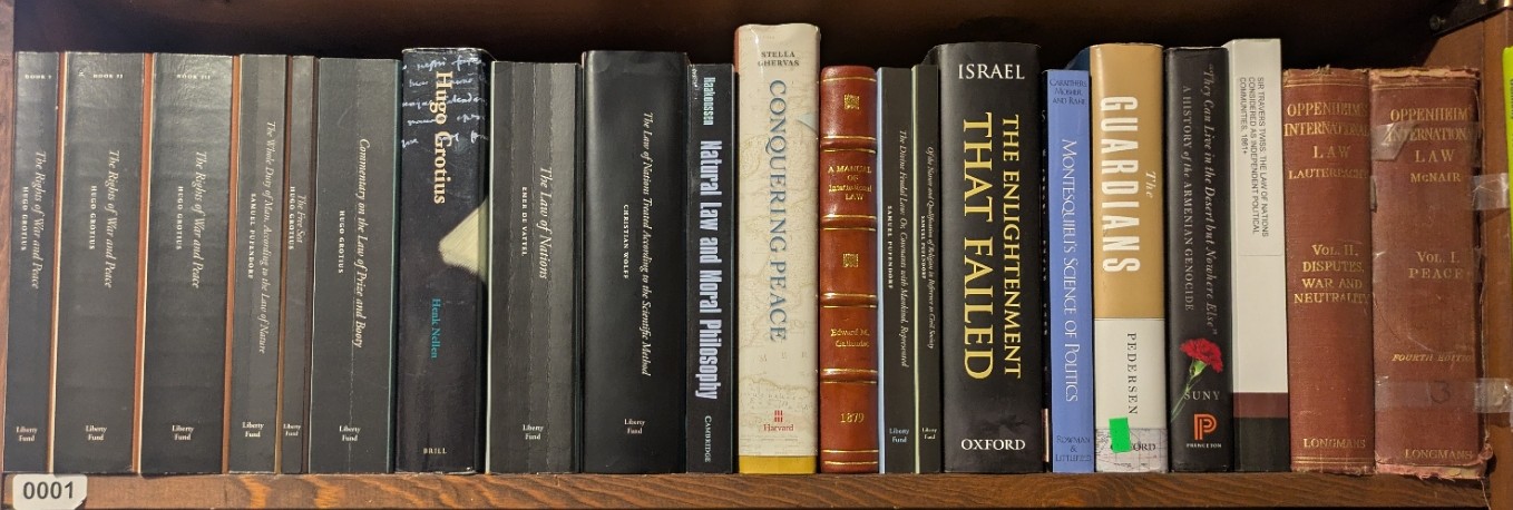 Photograph of Shelf 1; books are listed in top-to-bottom order alongside the photograph.