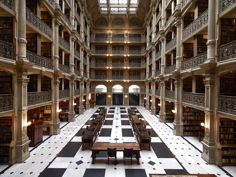 Interior of the Peabody Library in Baltimore, with tiers of book galleries around the reading room