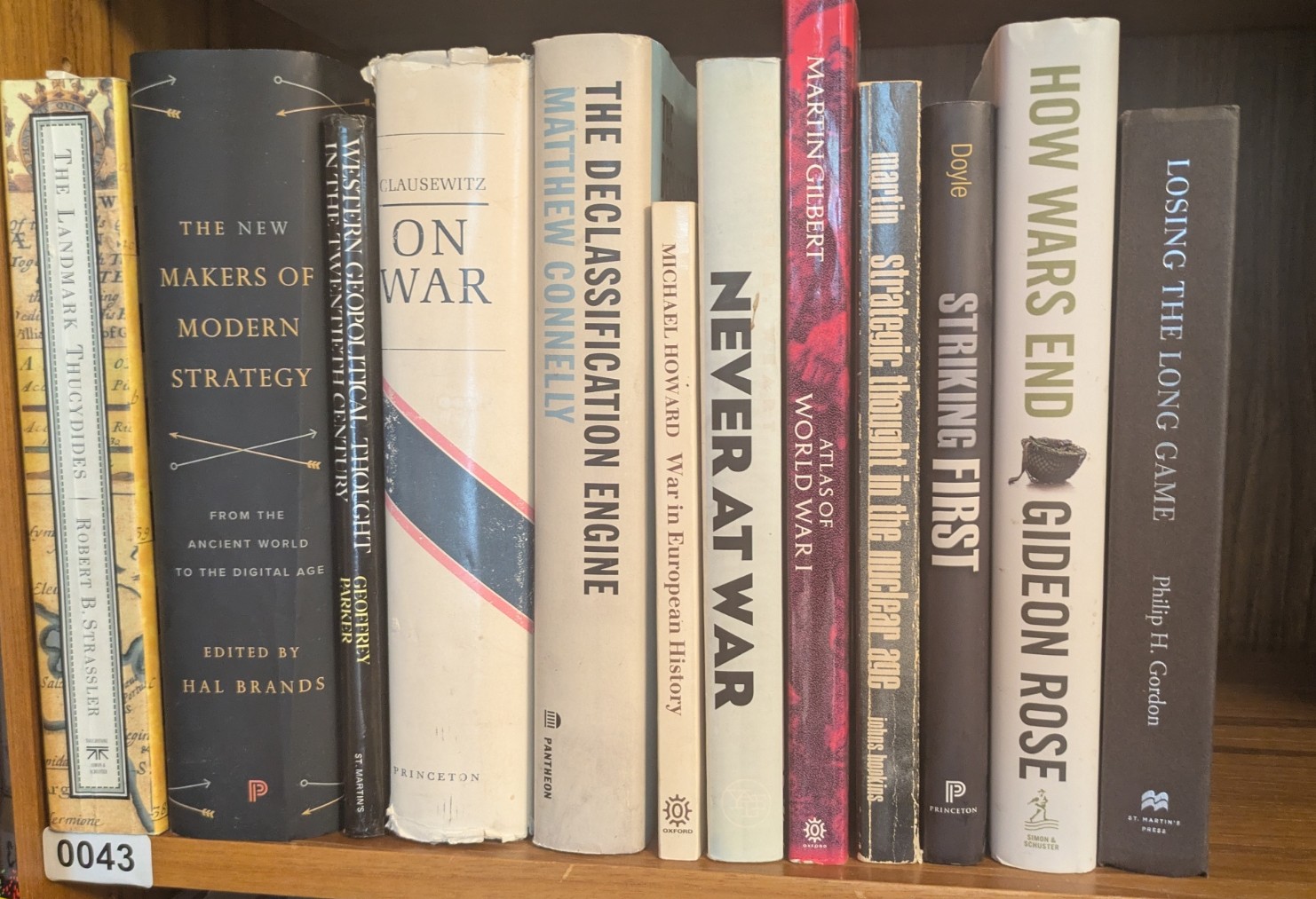 Photograph of Shelf 43; books are listed in top-to-bottom order alongside the photograph.