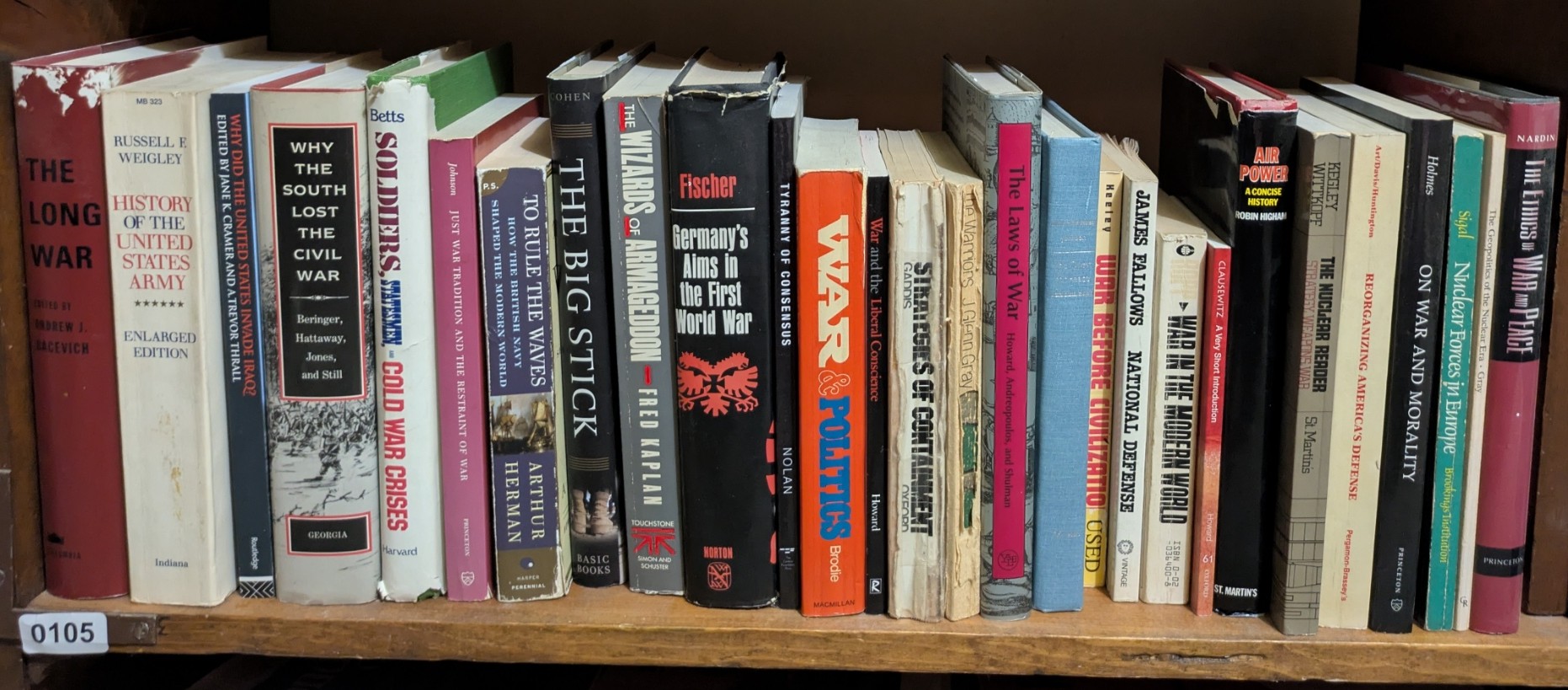 Photograph of Shelf 105; books are listed in top-to-bottom order alongside the photograph.
