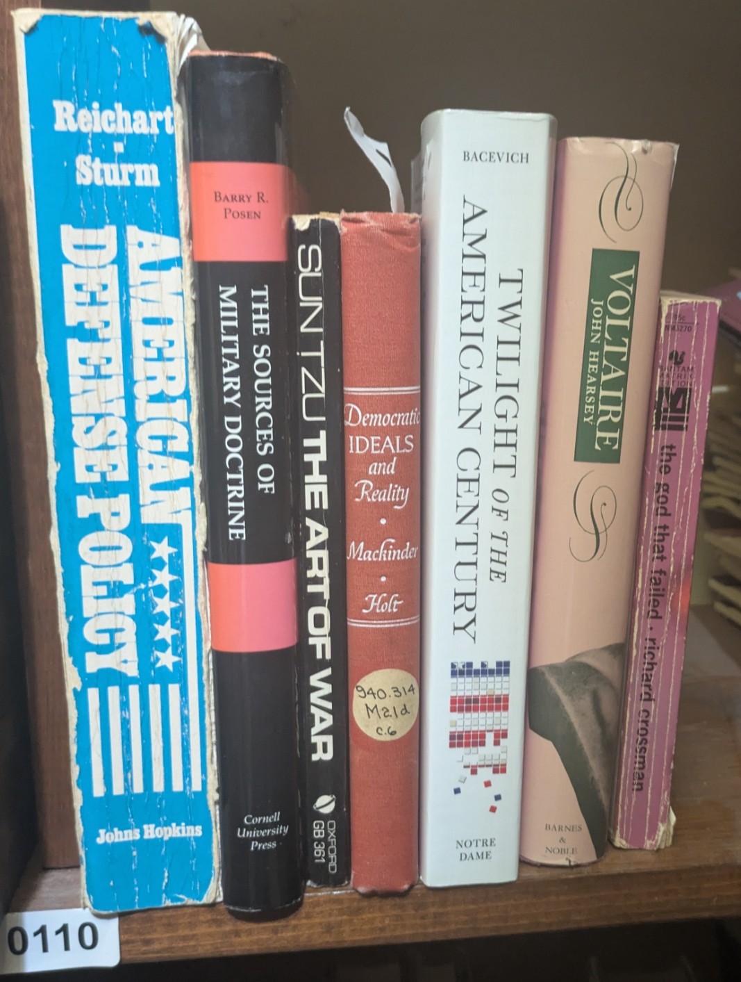 Photograph of Shelf 110; books are listed in top-to-bottom order alongside the photograph.