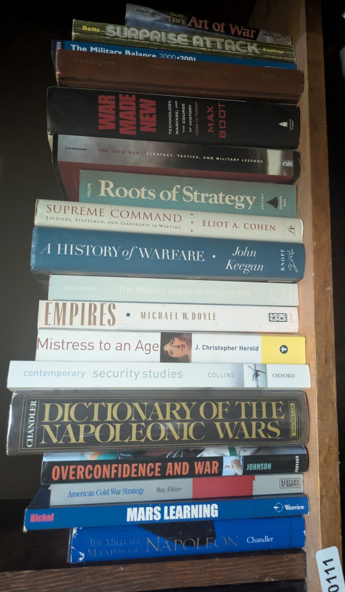 Photograph of Shelf 111; books are listed in top-to-bottom order alongside the photograph.
