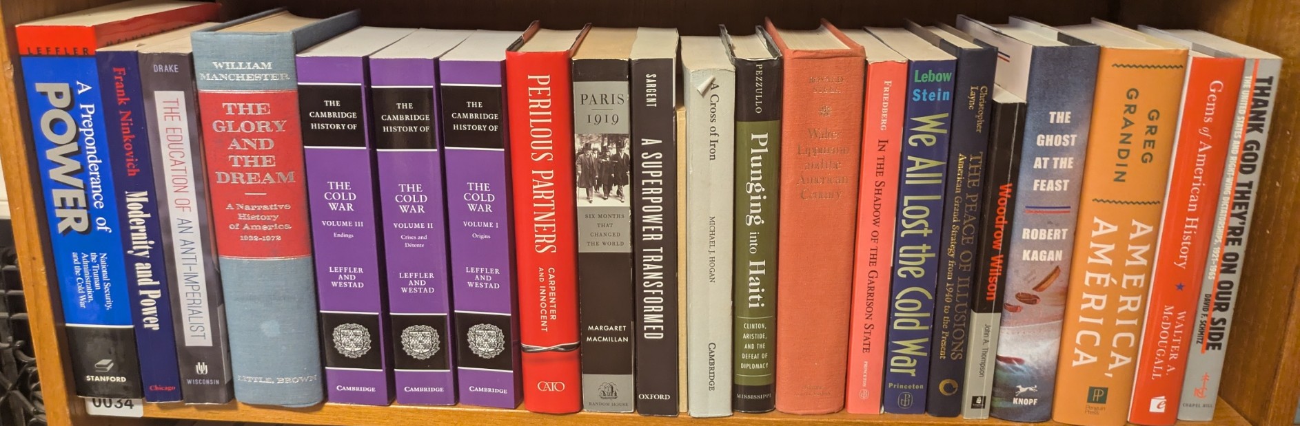Photograph of Shelf 34; books are listed in top-to-bottom order alongside the photograph.