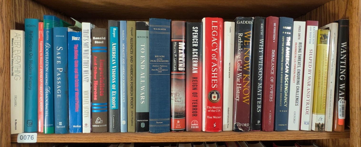 Photograph of Shelf 76; books are listed in top-to-bottom order alongside the photograph.