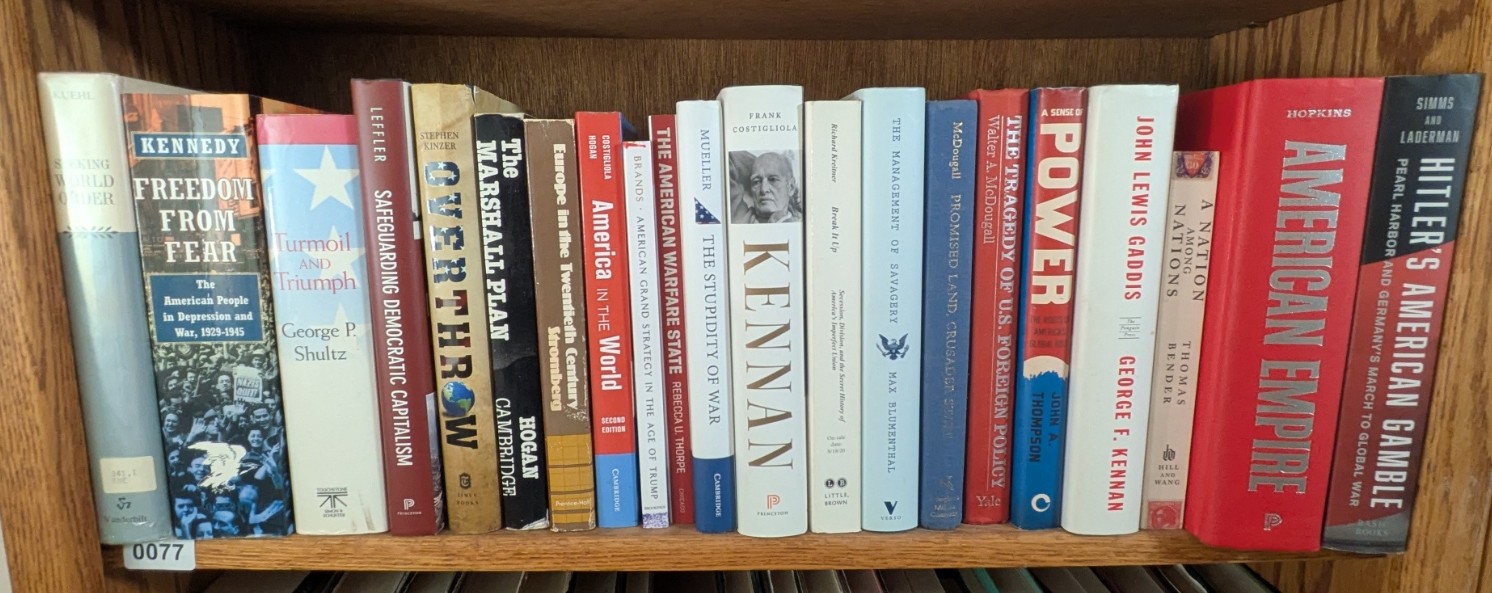 Photograph of Shelf 77; books are listed in top-to-bottom order alongside the photograph.