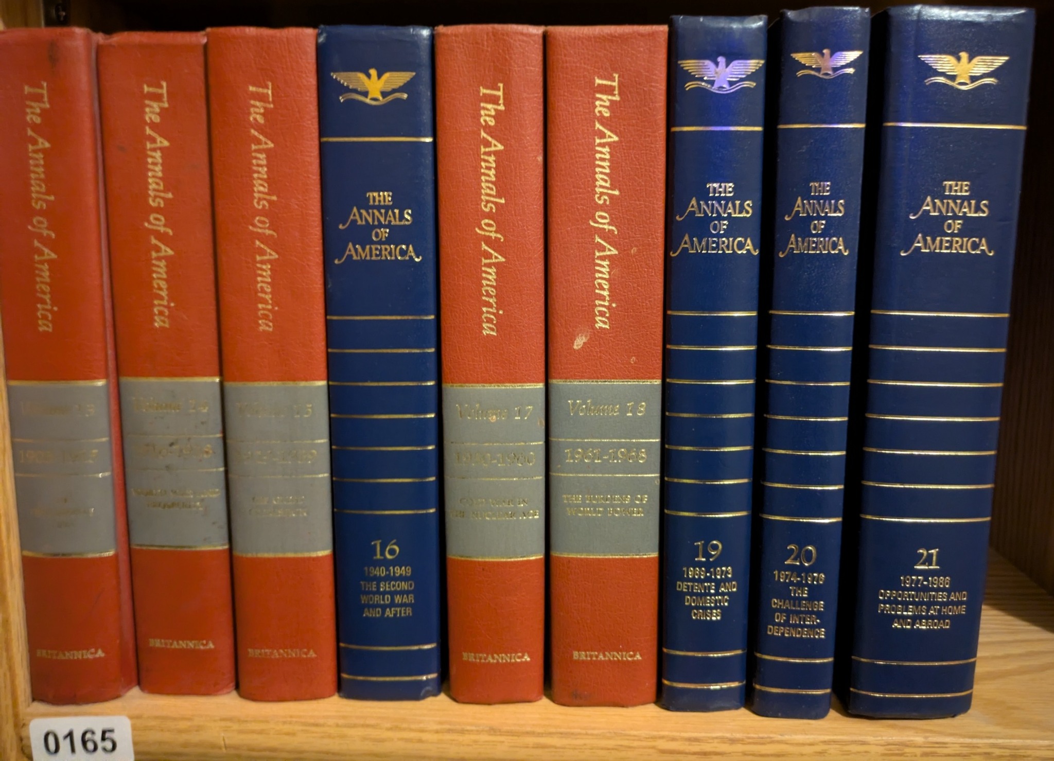 Photograph of Shelf 165; books are listed in chronological order below the photograph.