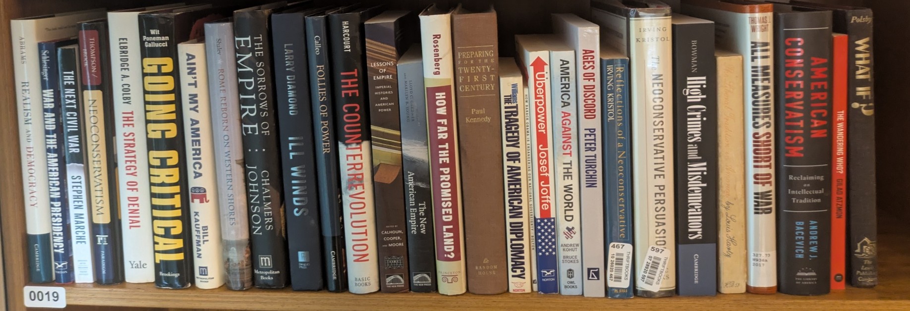Photograph of Shelf 19; books are listed in top-to-bottom order alongside the photograph.