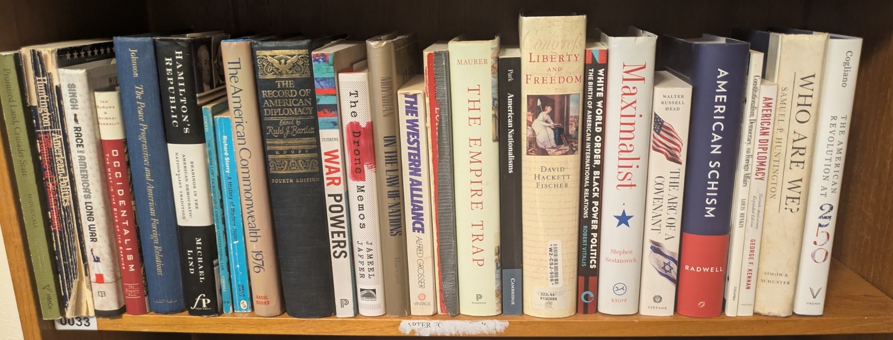 Photograph of Shelf 33; books are listed in top-to-bottom order alongside the photograph.