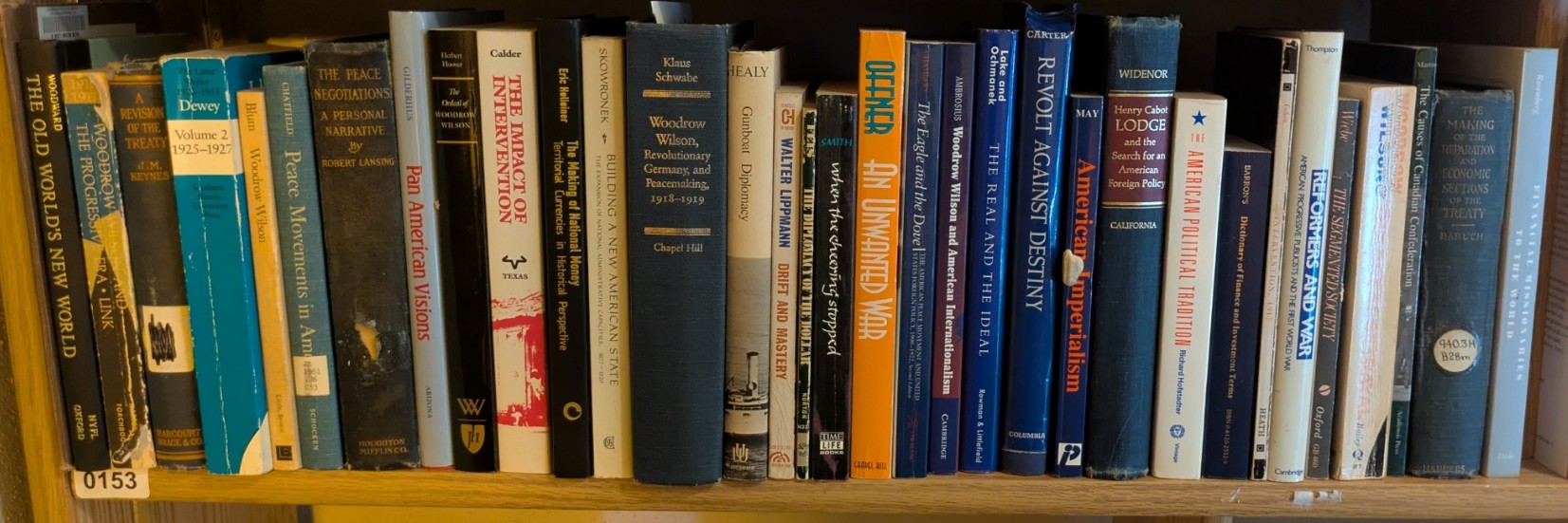 Photograph of Shelf 153; books are listed in top-to-bottom order alongside the photograph.
