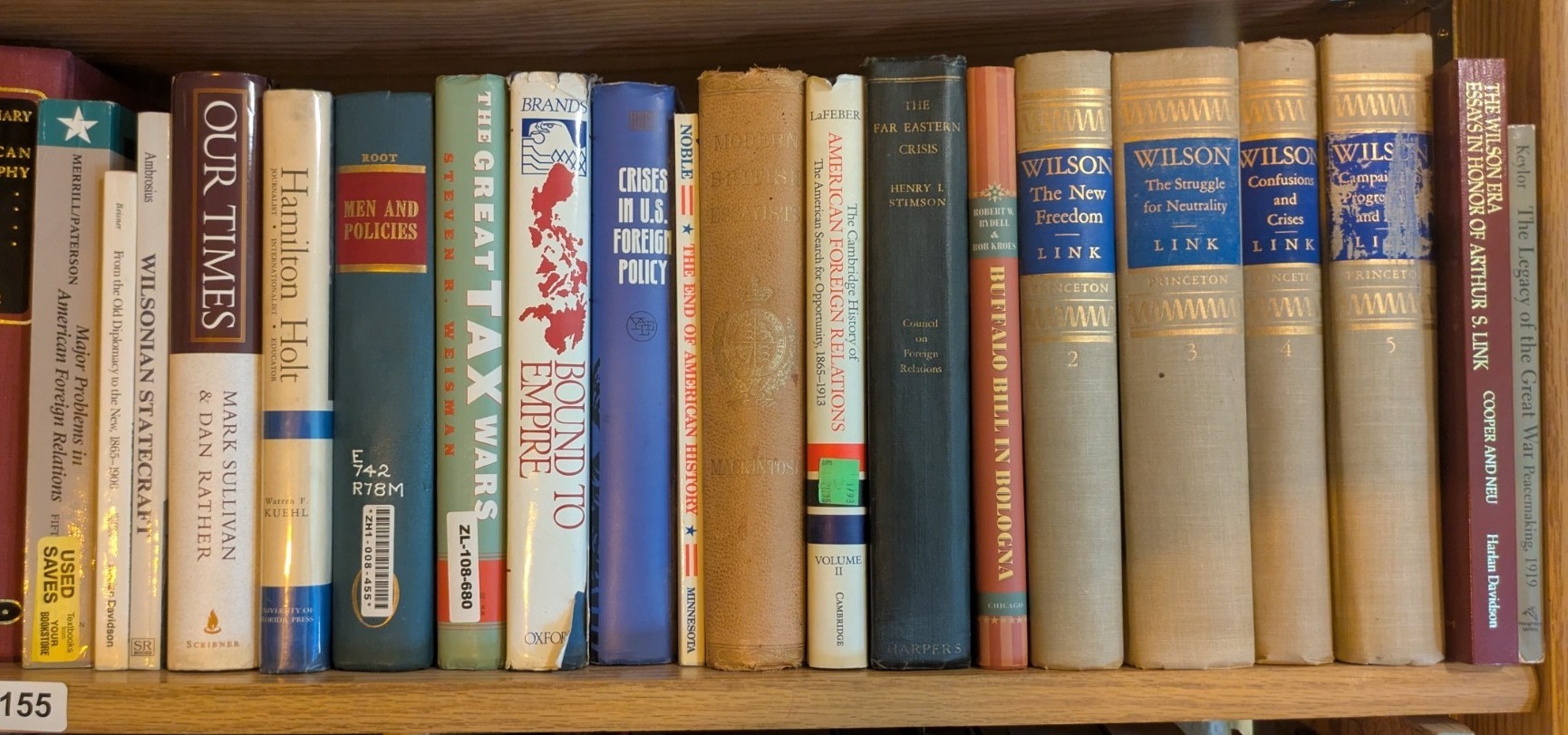 Photograph of Shelf 155; books are listed in top-to-bottom order alongside the photograph.
