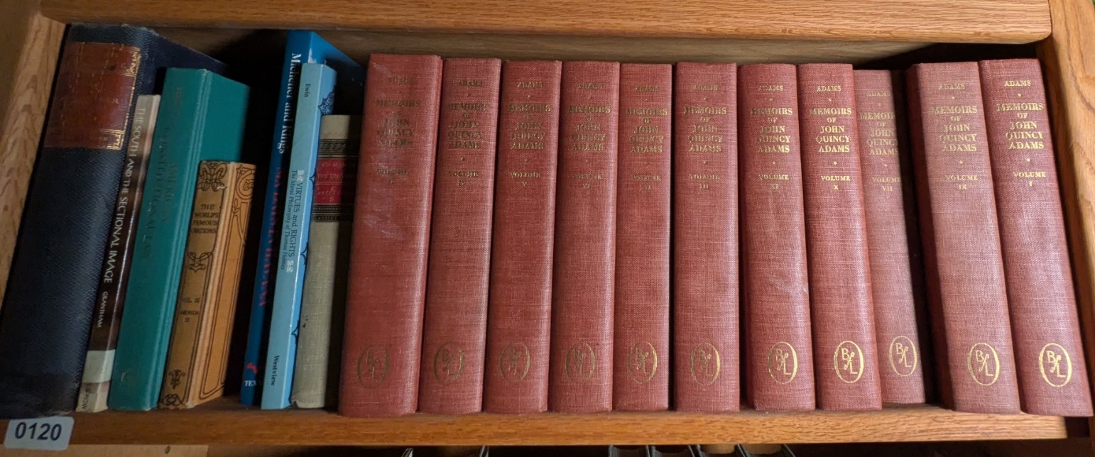 Photograph of Shelf 120; books are listed in top-to-bottom order alongside the photograph.