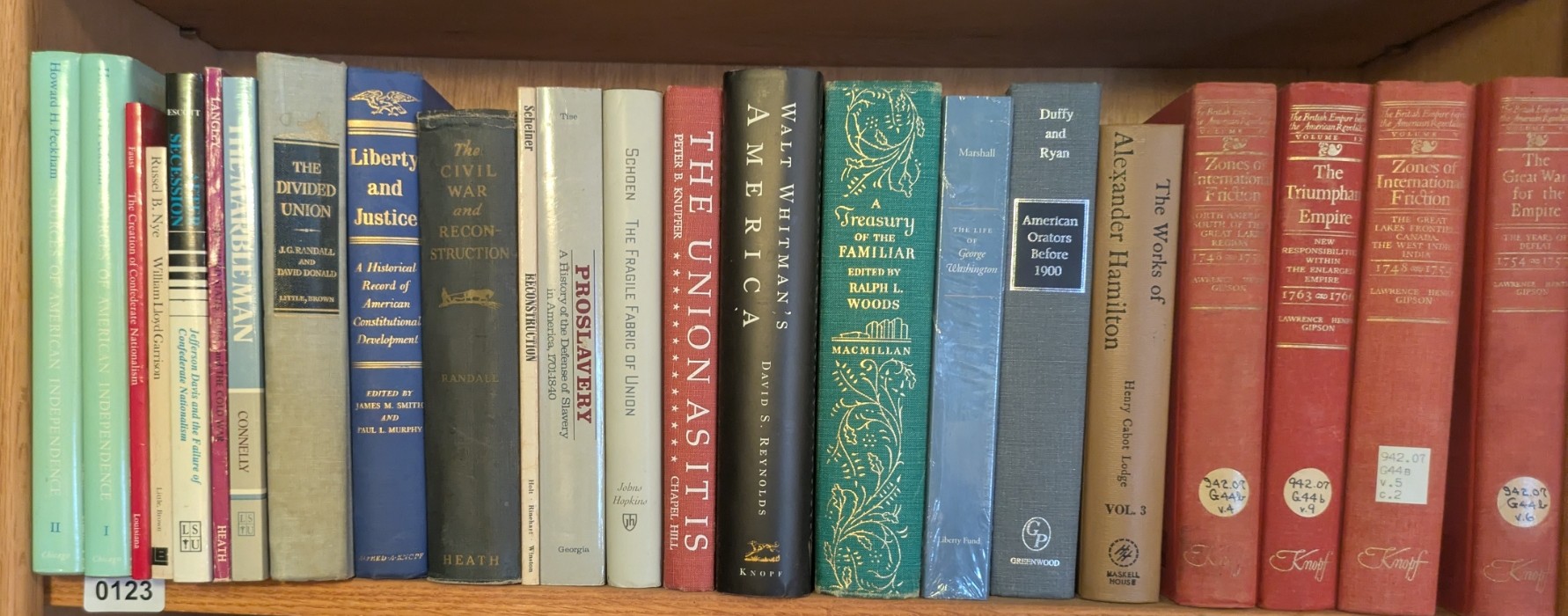 Photograph of Shelf 123; books are listed in top-to-bottom order alongside the photograph.