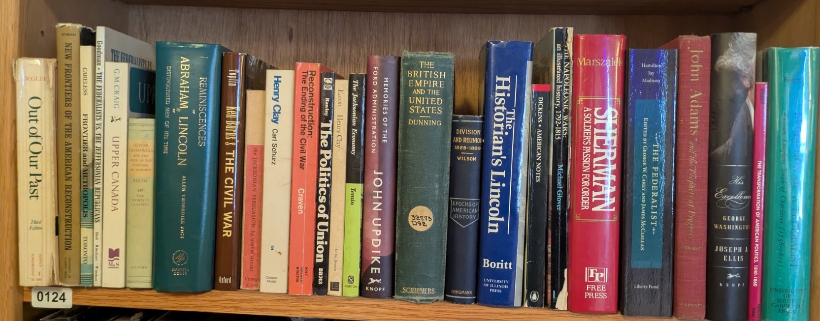 Photograph of Shelf 124; books are listed in top-to-bottom order alongside the photograph.