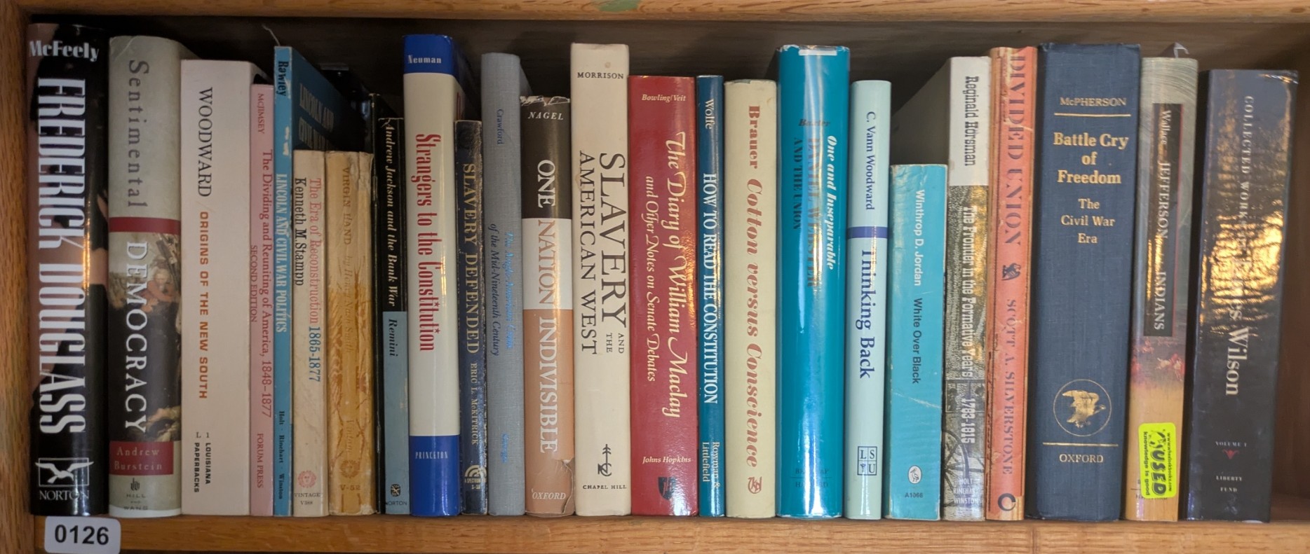 Photograph of Shelf 126; books are listed in top-to-bottom order alongside the photograph.